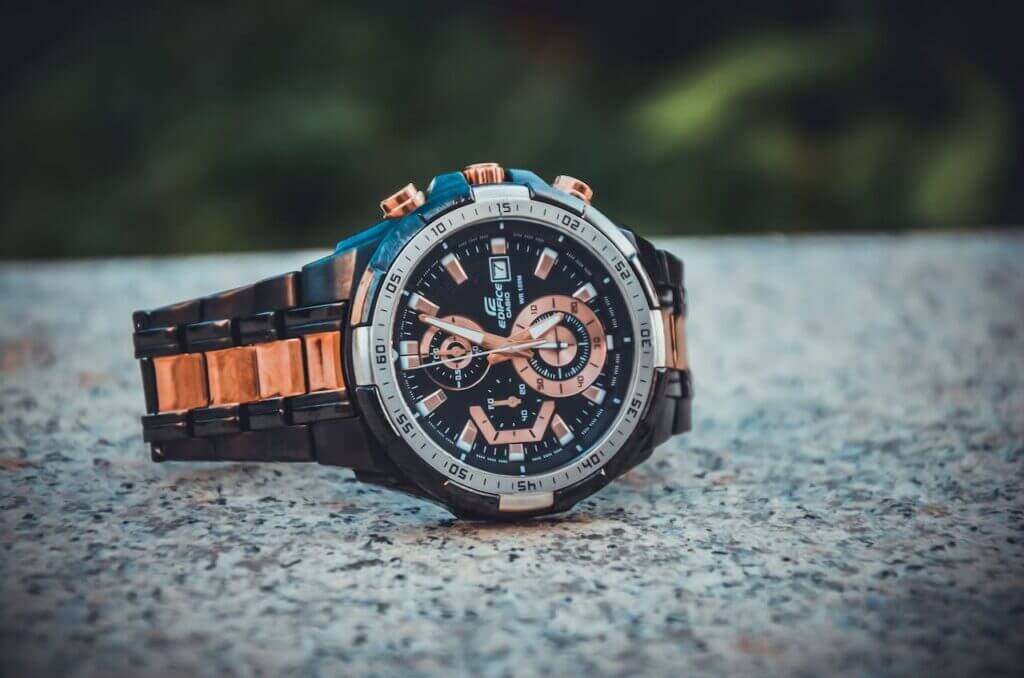 Top Watch Close-up of an elegant wristwatch with a metal band, highlighting its intricate design and timekeeping features.